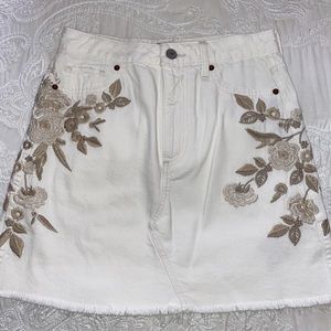 White mini skirt with tan embroidered flowers